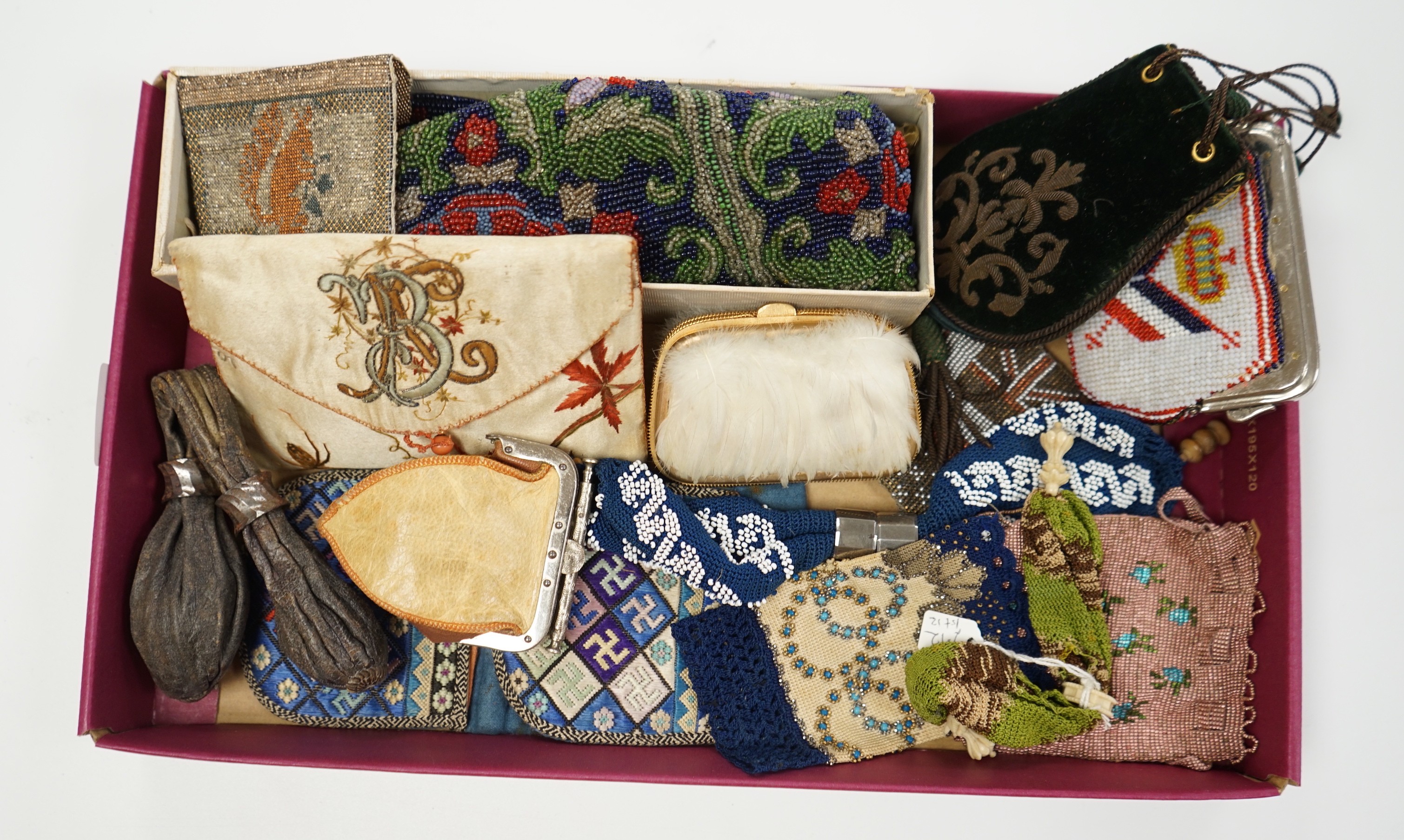 A velvet and metal embroidered reticule possibly 18th century, together with a collection of beaded embroidered knitted and leather purses, bags misers purses and a feather coin purse(14)